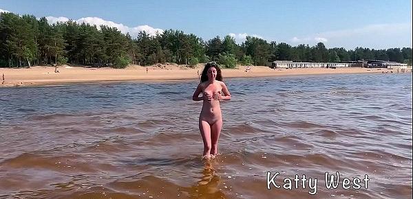  Cute girl sunbathes on a nudist beach and pisses in public